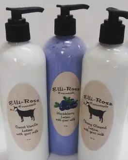 Three bottles of lotion and a bottle with a cow on it.