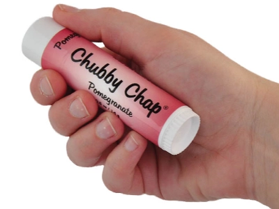 A hand holding a chubby chap lip balm.